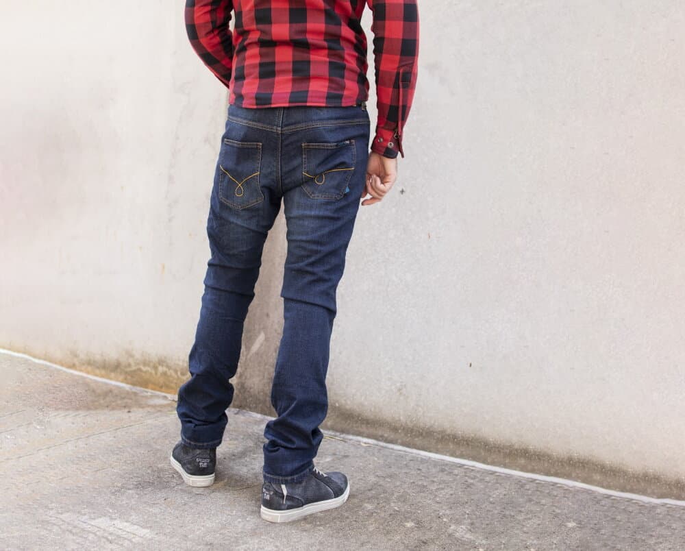 Rear view of rider wearing motorcycle dress shoes with D3O protection and reinforced denim jeans